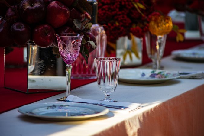 Close up of pink crystal wine glass at elegant formal dinner table