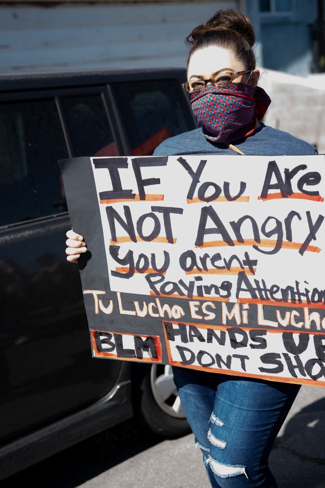 Los Angeles, CA, USA — June 7th, 2020: woman posing with protest sign at rally in East LA