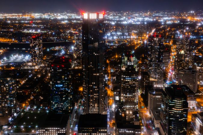 Helicopter Tour of New York City Architecture at Night. Midtown Manhattan Office Buildings and Skyscrapers. Aerial Urban Landscape with Lights at Night