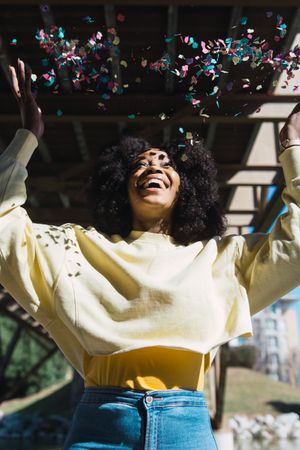 Woman throwing confetti in the air.