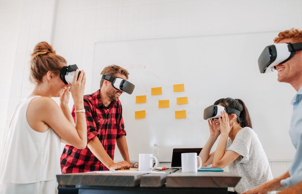 Team of developers working with virtual reality glasses during a business meeting