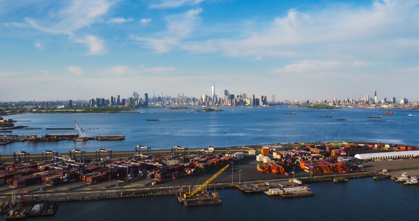 Aerial View of Manhattan Architecture. Panorama of New York City and Jersey City From a Helicopter, Showing Office Buildings and Skyscrapers. Camera Flies Over a Harbour Area with Shipping Containers