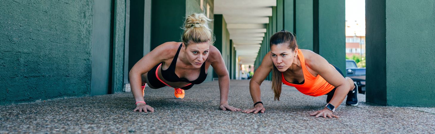 Sportswomen doing push-ups