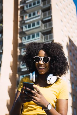 Black woman listening to music with headphones.