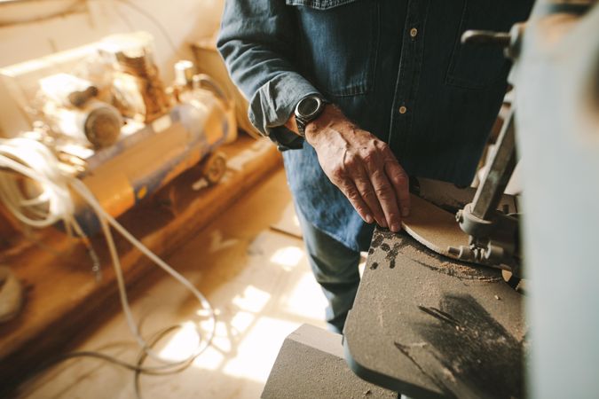 Focus on carpenter hand working in carpentry shop