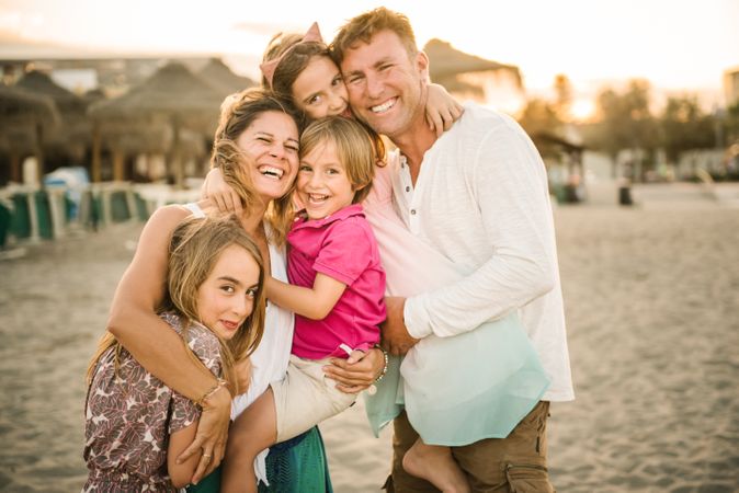 Beautiful happy family with children on beach