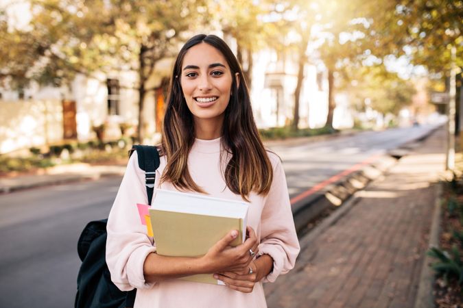 Female college student smiling at camera while on school campus