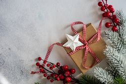 Christmas pine and holly with ribbon wrapped gift