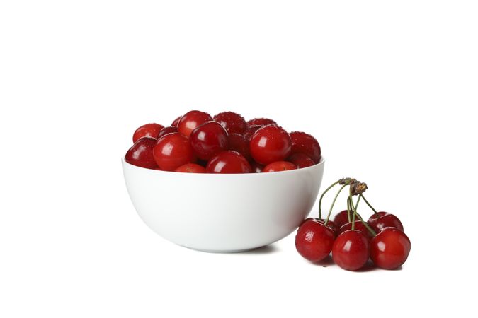 Bowl with fresh red cherry isolated on plain background