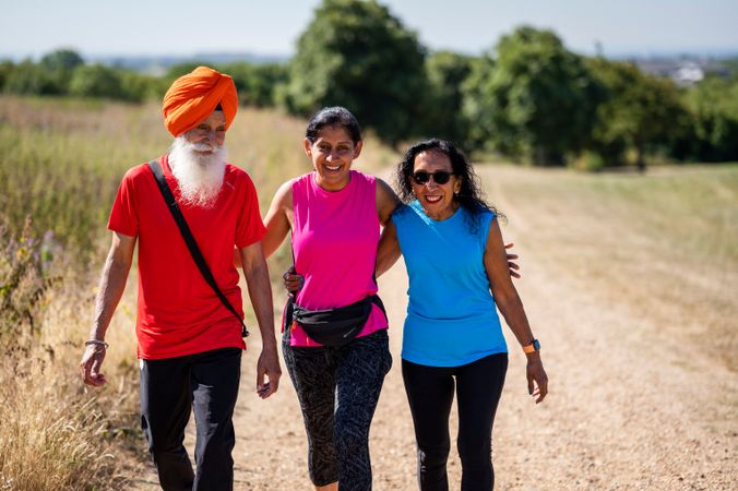 Mature Sikh family going for stroll in park
