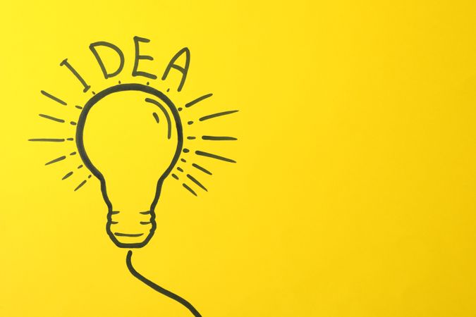 Drawn light bulb on yellow background. Good idea concept