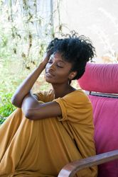 Close up of woman relaxing on garden patio with eyes closed