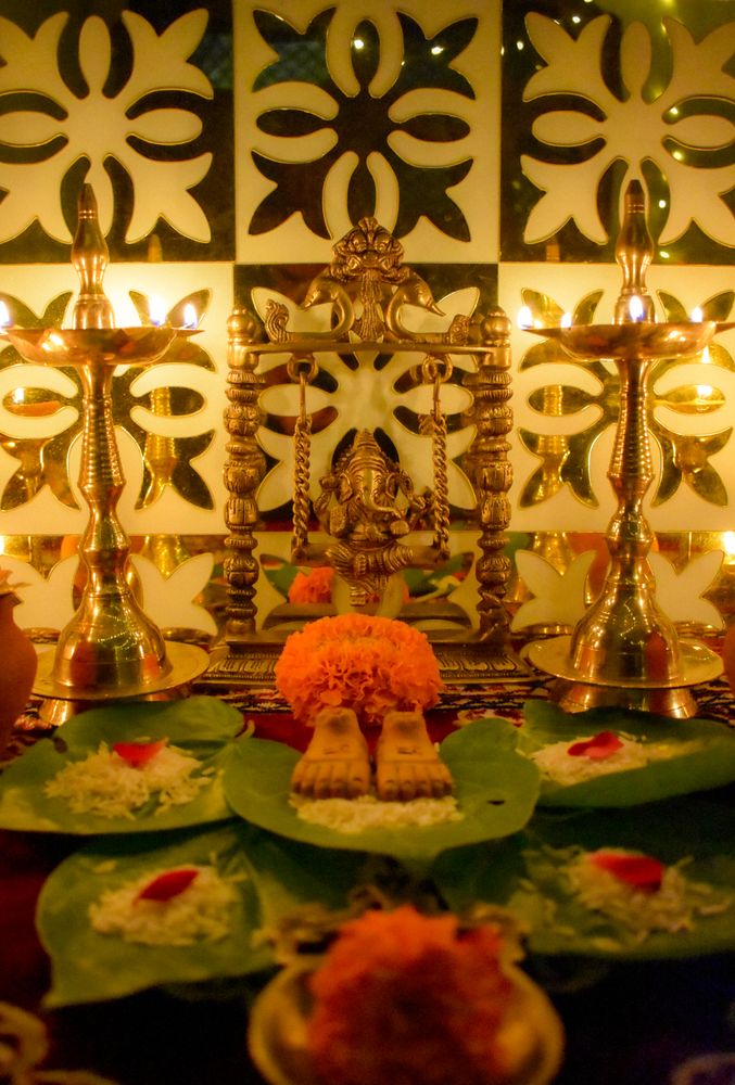 Saffron flowers and lit diyas on a table