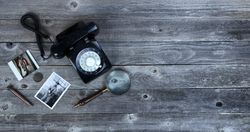 Old photos and other antiques on wood desktop
