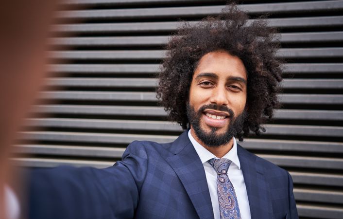 Joyful man taking selfie and smiling