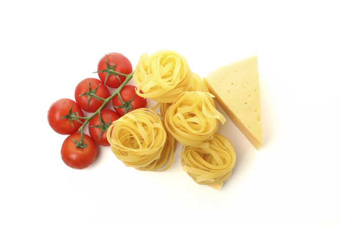 Tasty pasta and ingredients isolated on plain background