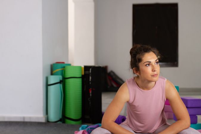Woman in sport wear resting looking away