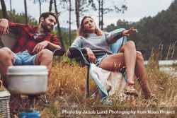 Relaxed young couple camping by the lake bx1OX0