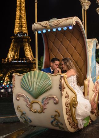 Just married couple in wedding suits taking amusement rides