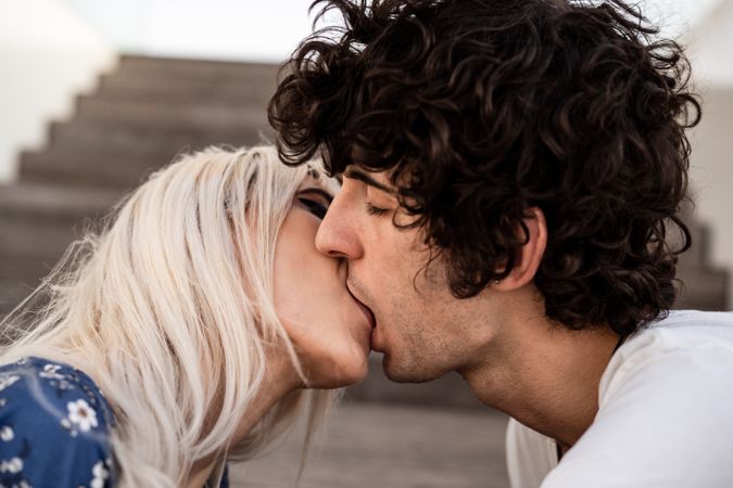 Loving couple kissing on stairs