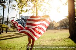Woman running with American flag on a sunny day 41wwL0