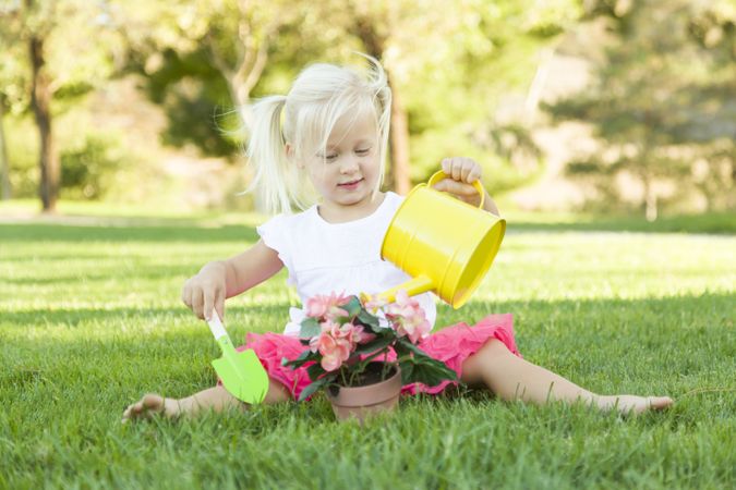 Cute Little Girl Playing Gardener with Her Tools and Flower Pot.