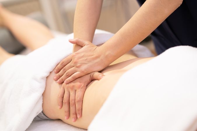 Woman receiving a back massage in a physiotherapy center