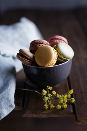 Dill flower near bowl of macaroons