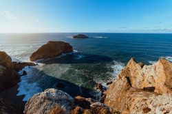 High cliff near water in sunny day