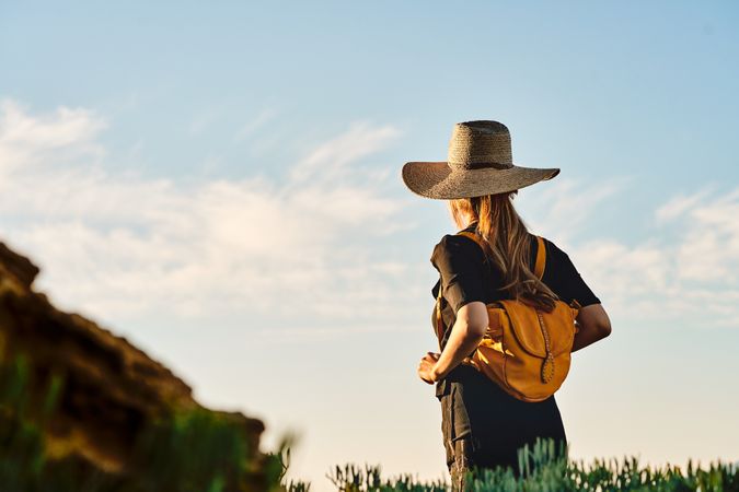 Woman traveler in straw hat walking