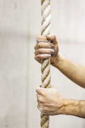 Man holding rope in gym