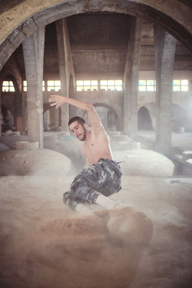 B boy performing dance in old cathedral