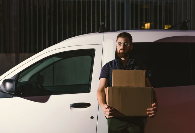 Dedicated upset courier with cartons waiting client for delivery completion
