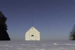 A rural town hall in a snowy field