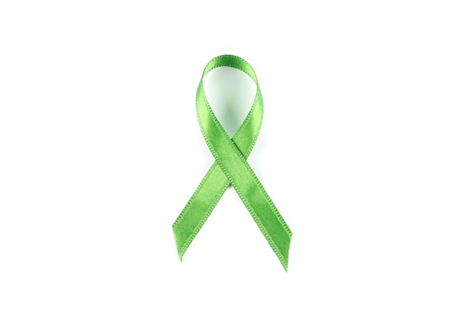 Green awareness ribbon isolated on blank background