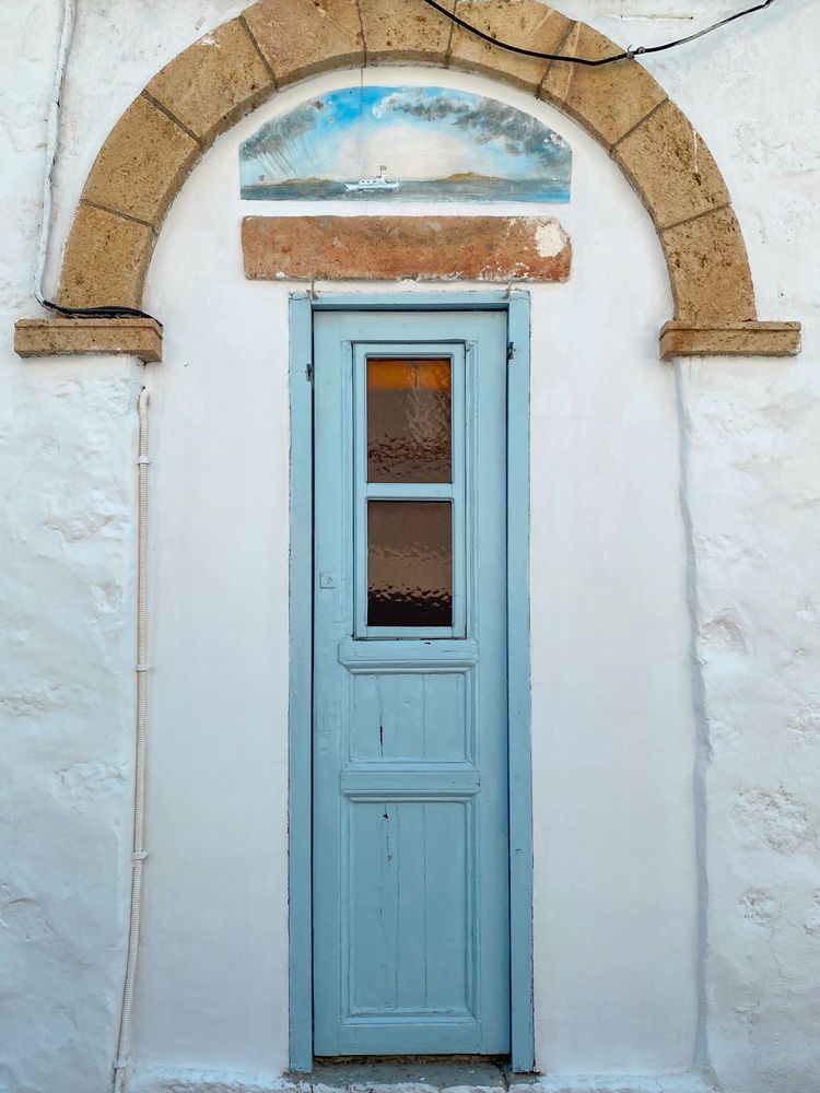 Patmian blue door with archway