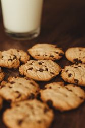 Savoring Simplicity: Homemade Cookies with a Glass of Milk on an Elegant Wooden Table.