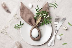 Napkin in rabbit ear shape on plate with egg in center