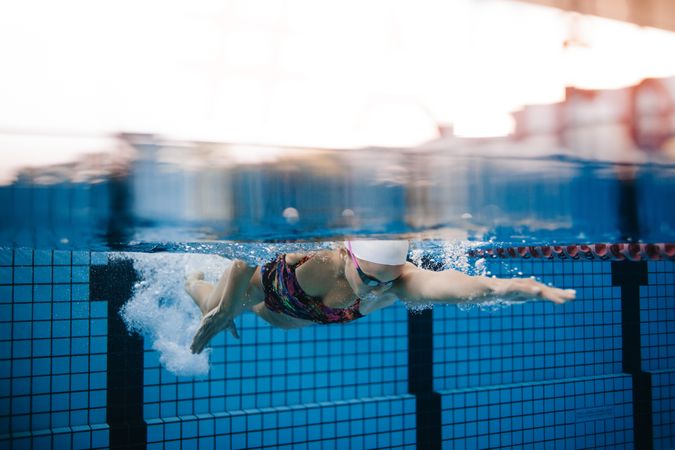 Female swim coach taking a swim in lap pool