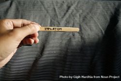 The word “inflation” written on wooden stick being held by person 0yLkWb