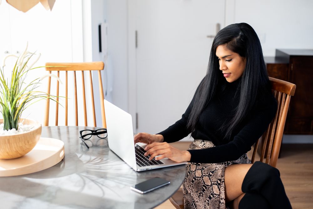 Businesswoman working from home on her computer