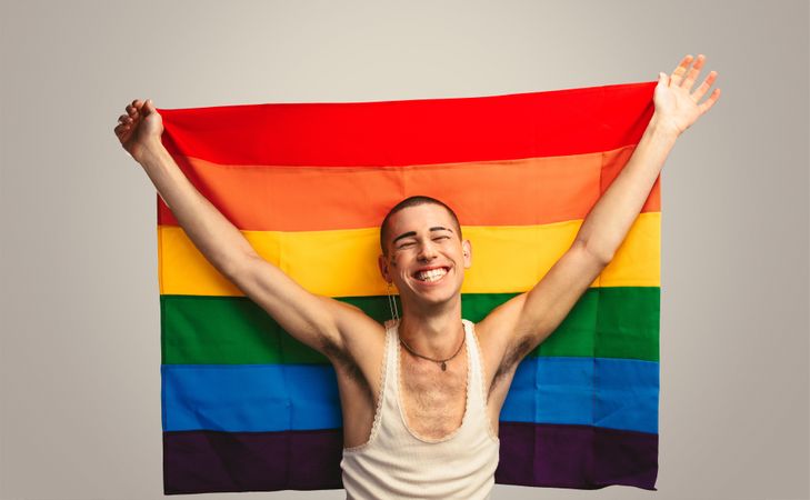 Smiling man with pride flag