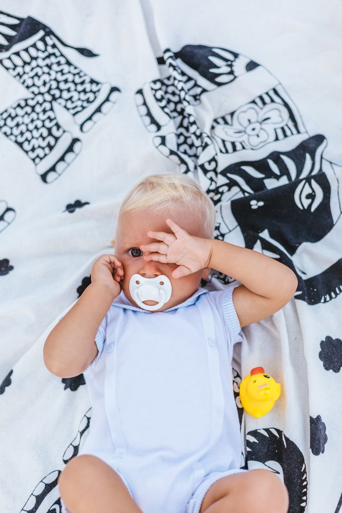 Blonde baby with sleepy expression