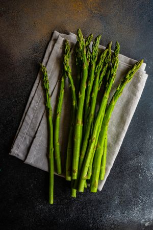 Raw asparagus on grey napkin