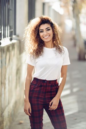 Portrait of smiling Arab woman standing outside