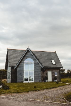 Grey wooden house and cloudy sky