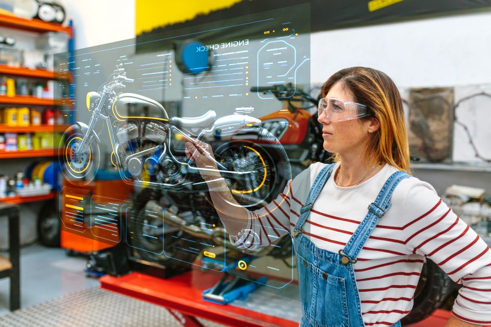 Female mechanic touching hud panel screen with augmented reality hologram to review motorcycle