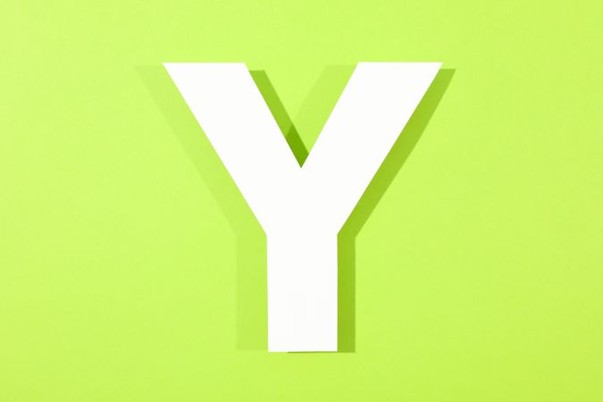 Paper letter Y on color background, space for text