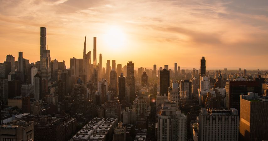 New York City Aerial Evening Cityscape with Stunning Manhattan Landmarks, Skyscrapers and Residential Buildings. Panoramic Helicopter View of a Popular Travel Destination