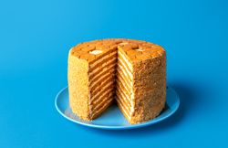 Homemade honey layered cake, russian recipe,  isolated on a blue background